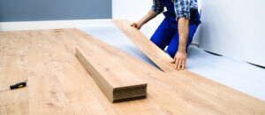Worker installing flooring