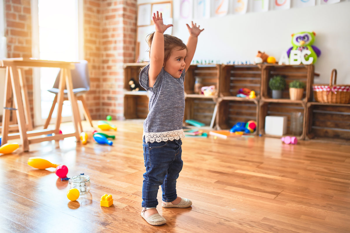 Happy Toddler on hardwood floor