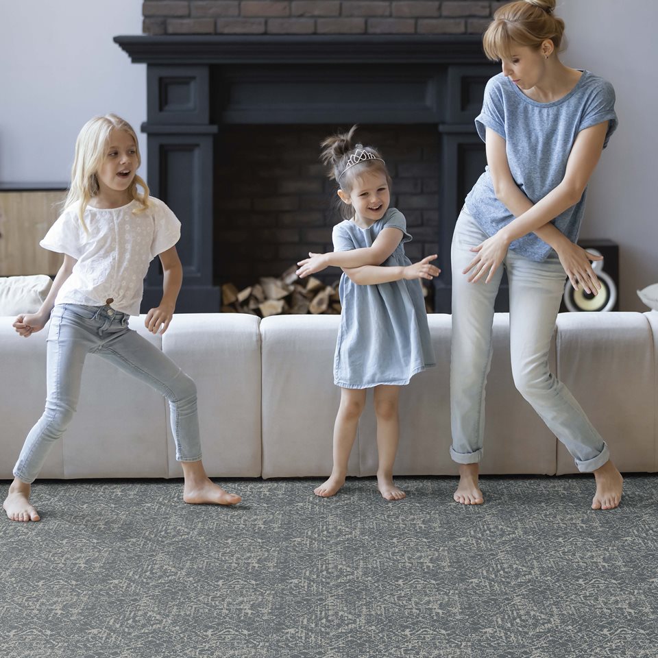 2 kids with their Mom dancing on carpet