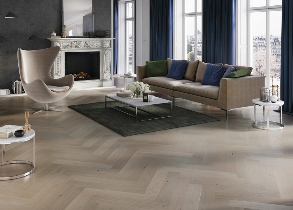The Noyer Highlands Collection features spectacular premium hardwood grains in several different colors. Shown here is the color Germain in a herring bone pattern. Each plank has a subtle micro-bevel and has a brush texture to bring out the grain.