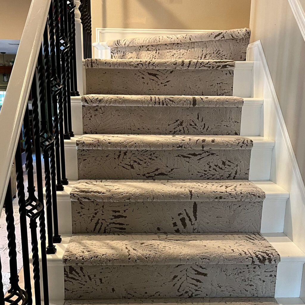beautiful foliage motif patterned carpet installed on stairs
